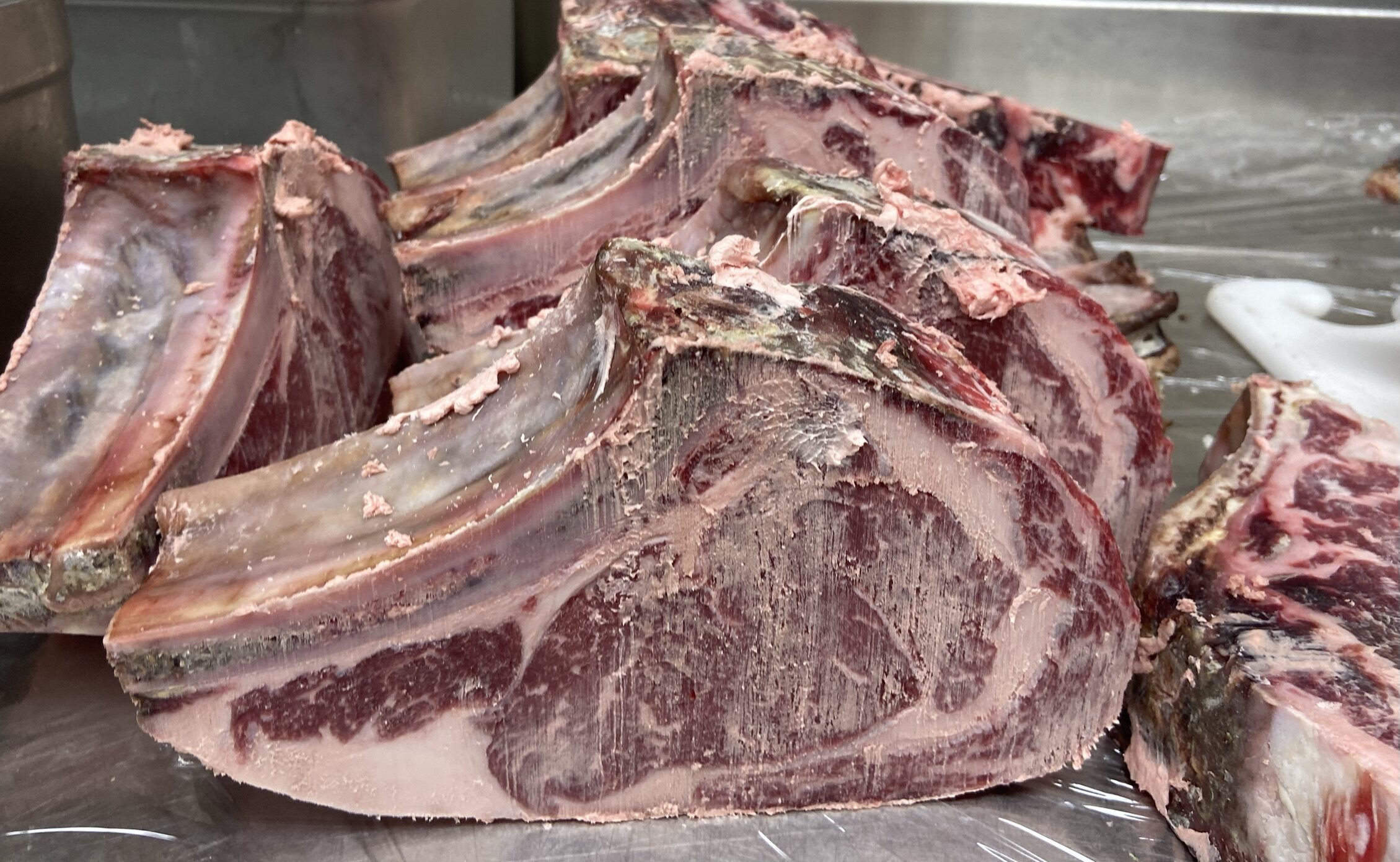 Stacked dry-aged chops ready for cutting
