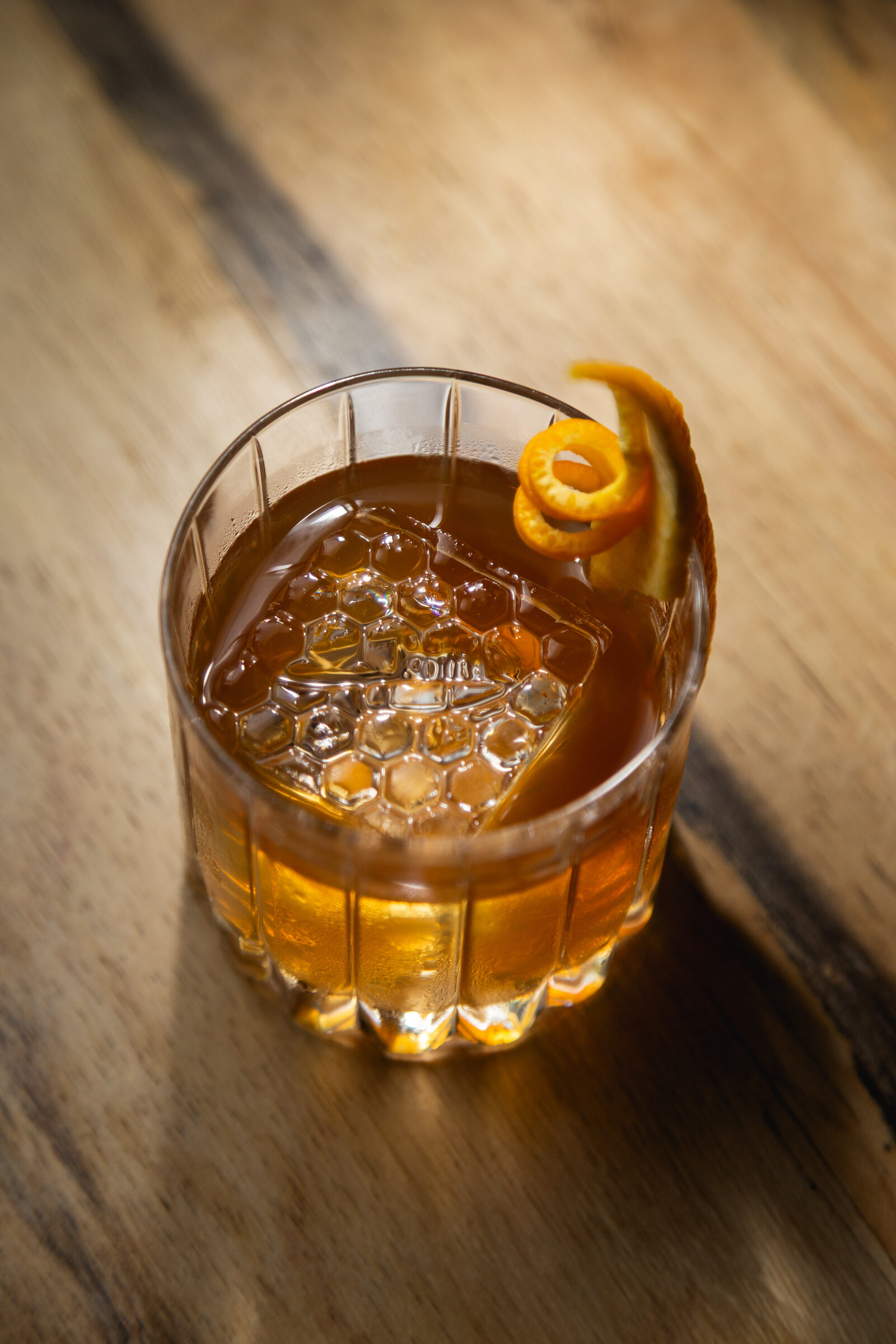 An old fashioned over a large ice cube
