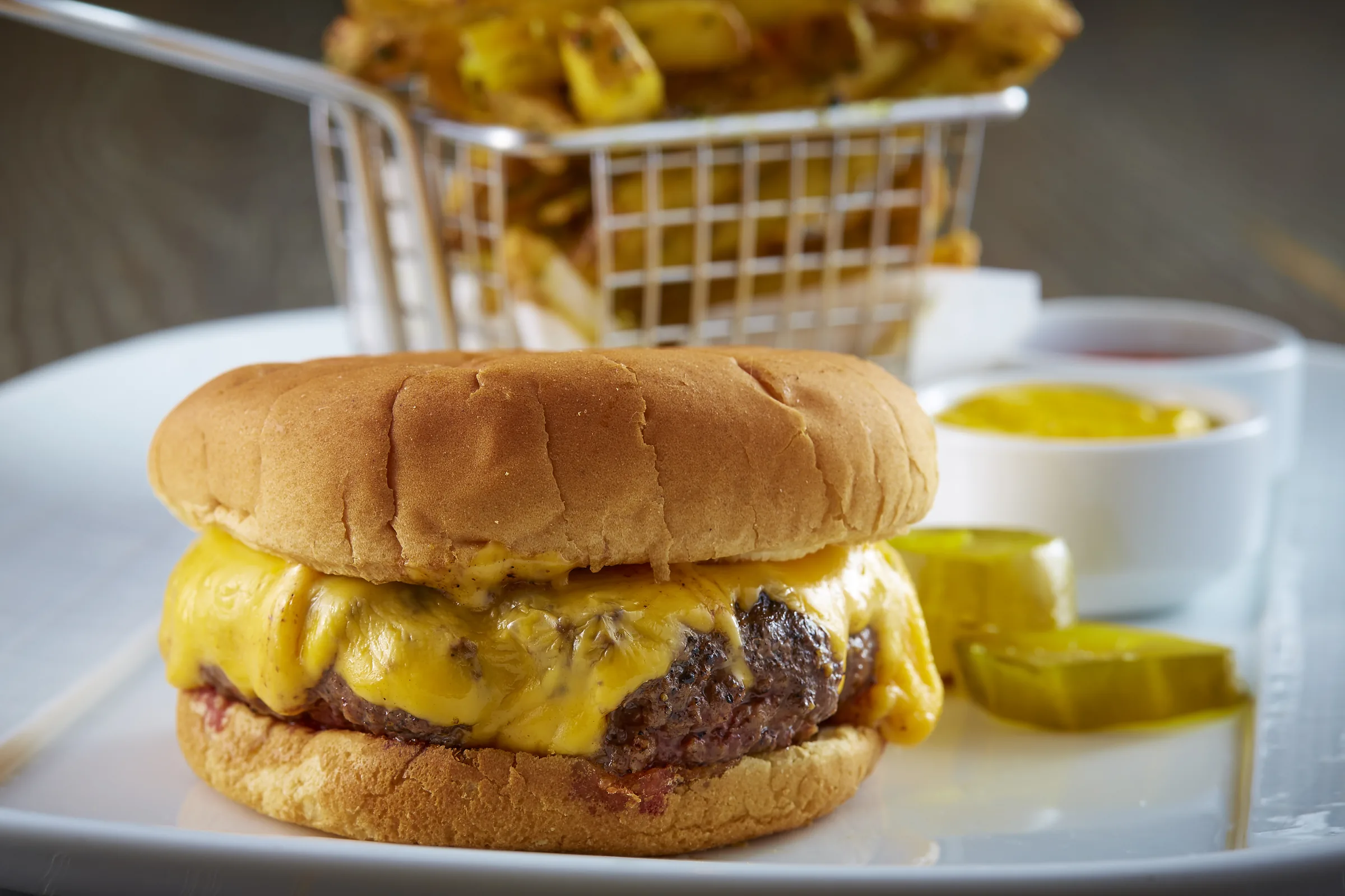 The Ozersky burger with fries at Knife Steakhouse Plano