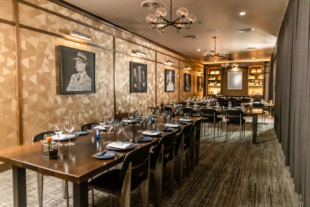 The private dining room with portrait wall at Knife Steakhouse Plano