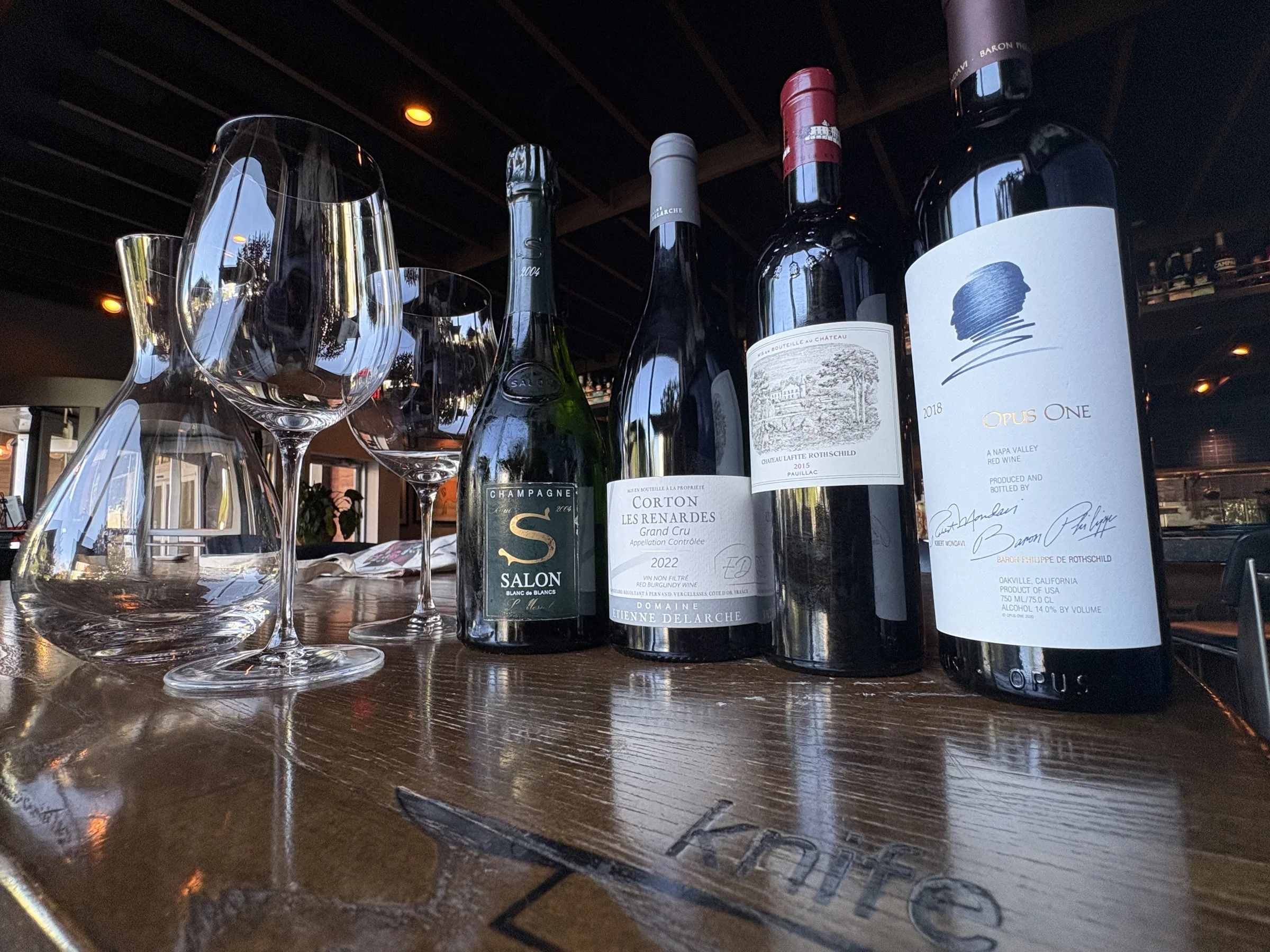 Rare and collectible bottles lined up on the bar at Knife Steakhouse Plano