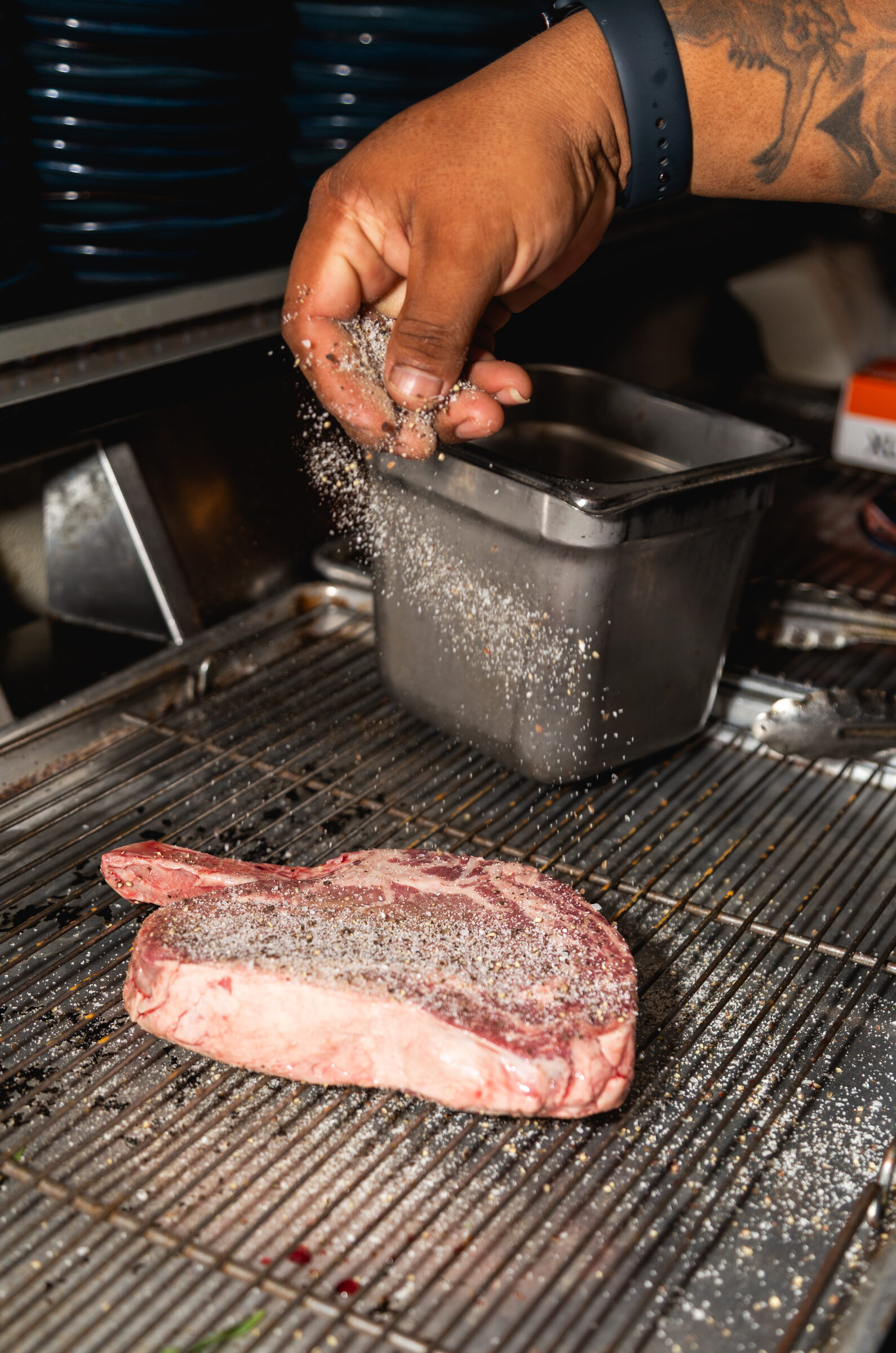 Seasoning a steak during prep