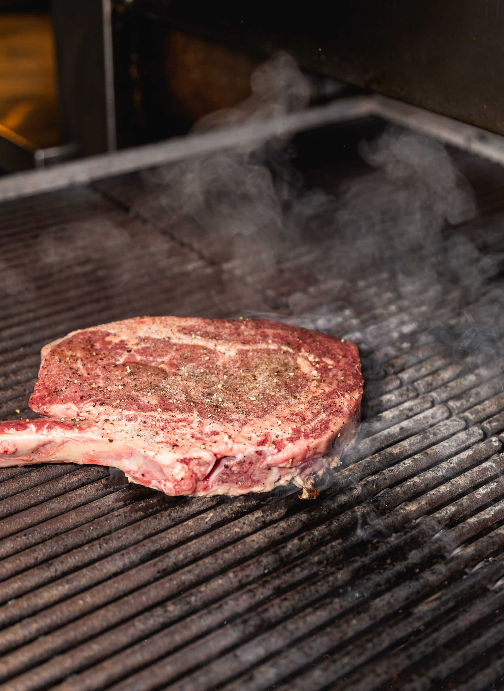 A tomahawk ribeye on the grill