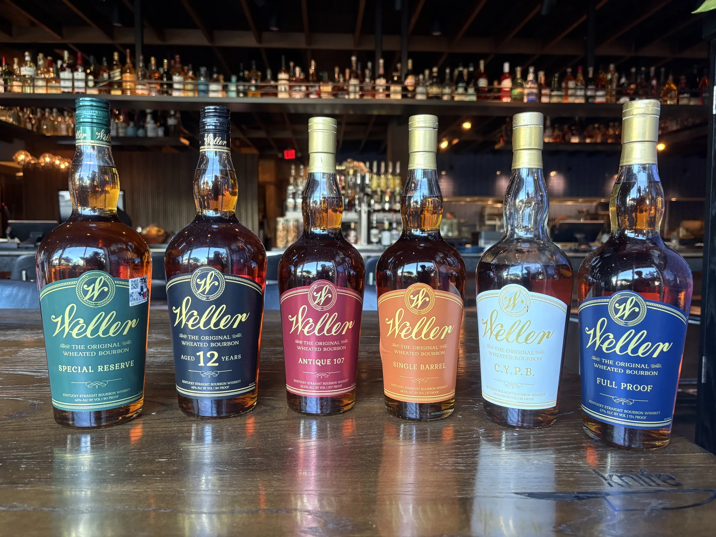 Weller whiskey bottles at the bar at Knife Steakhouse Plano